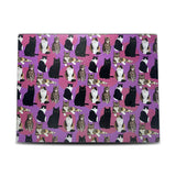 Cutting board with multiple different cats with a purple background