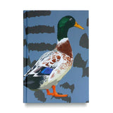 Hardback Notebook Duck with striking colours standing with a blue background
